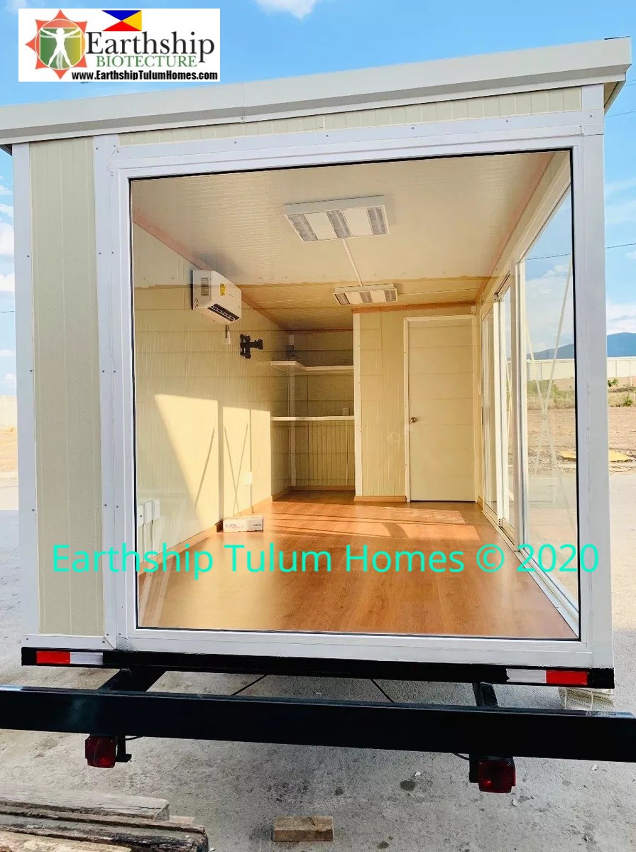 Mobile container equipped with 2.4 m tall slanted roof, AC, small bathroom, Doors, Windows, & Lighting. 